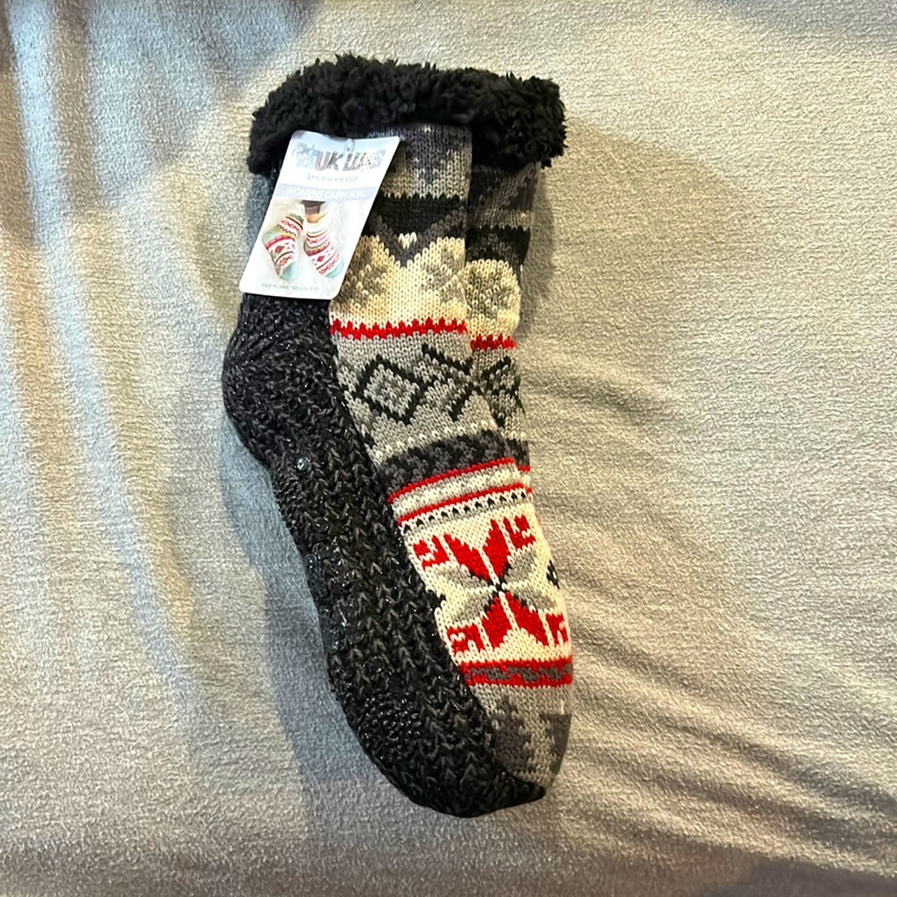 Women’s cabin sock. Gray, red and charcoal coloring. Non-slip grip bottom.